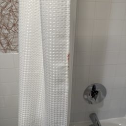 Either blood or some other dark red substance on the shower curtain. Gross!