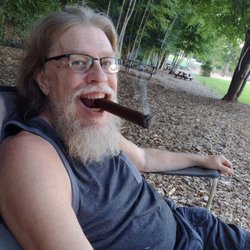 Tobacco Merchant of Hendersonville - Puffing on a tasty cigar out in the Firefly field at Blue Ghost brewing.