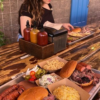 Caldwell County BBQ - El General Patton Sandwich, East Side Pig, Aunt Susan's Corn Casserole, Julio's Mac 'N Cheese, and and extra Sausage Link. - Barbeque Near Me - Gilbert, Arizona Caldwell County BBQ - El General Patton Sandwich, East Side Pig, Aunt Susan's Corn Casserole, Julio's Mac 'N Cheese, and and extra Sausage Link. - Barbeque Near Me - Gilbert, Arizona