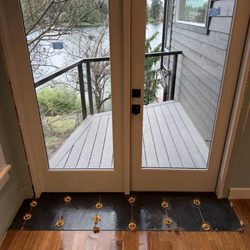 Instead of replacing the entire hardwood flooring, we laid tile on the entryway to improvise and save the homeowner on cost
