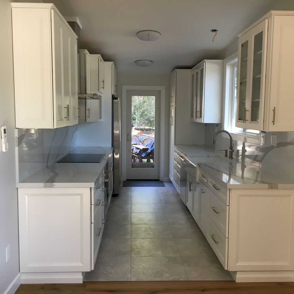 ZV Construction - a long narrow kitchen with white cabinets - Flooring Near Me - Napa, California