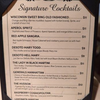 General's Restaurant - Signature Cocktails, gotta have the Generals Manhattan with Southern Comfort. - A printed cocktail menu titled 'Signature Cocktails' lists drinks like Wisconsin Sweet Bing Old Fashioned, Aperol Spritz, and Red Apple Sangria, with descriptions and prices. - New American Near Me - Galena, Illinois