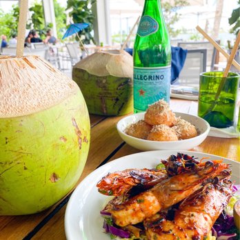 Amara at Paraiso - Calm before the Coconut (drink), Yuca Cheese Puffs & Spicy Grilled Tiger Prawns - Latin American Near Me - Miami, Florida Amara at Paraiso - Calm before the Coconut (drink), Yuca Cheese Puffs & Spicy Grilled Tiger Prawns - Latin American Near Me - Miami, Florida