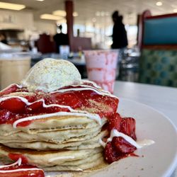 L&G Family Restaurant - Strawberry Cheesecake Pancakes with fresh strawberries, and homemade puree topped with a vanilla drizzle