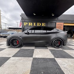 Pride Car Customizing - Tesla satin black wrap with a cool body kit and 22" custom painted rims.