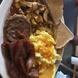 Sail Inn - Sausage, bacon scrambled eggs with cheese home fries with cheese and peppers. Wheat toast oranges.