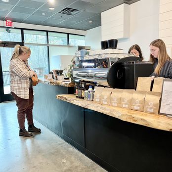 Quickwater Coffee Roasters - a woman serving a customer - Coffee & Tea Near Me - Rockford, Michigan Quickwater Coffee Roasters - a woman serving a customer - Coffee & Tea Near Me - Rockford, Michigan