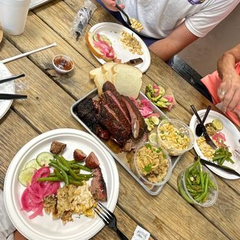 Butter’s BBQ - a man and woman sitting at a table with plates of food - Barbeque Near Me - Sinton, Texas Butter’s BBQ - a man and woman sitting at a table with plates of food - Barbeque Near Me - Sinton, Texas