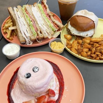 Burnt Crumbs - Strawberry soufflé pancakes / Classic club sandwich with fries / Vietnamese iced coffee / Sausage, egg, & cheddar breakfast sandwich - New American Near Me - Irvine, California