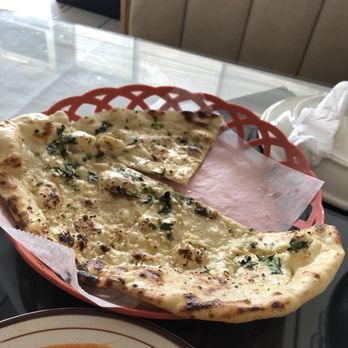 Shalamar Restaurant - Garlic naan with 1/4 already eaten - Pakistani Near Me - Webster, Texas