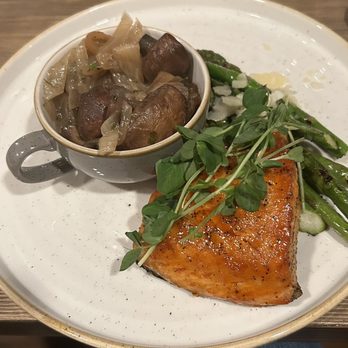 Salmon fillet, with a side of caramelized onions and mushrooms, and asparagus.