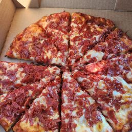 A small pepperoni pizza. A small pepperoni pizza.