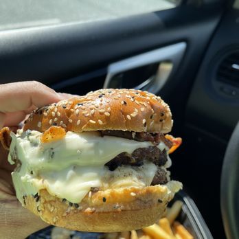 Miller's Ale House - $12.29 | Black & Blue Burger - Peppered bacon, blue cheese crumbles, melted white American cheese, blue cheese sauce and garlic-lime crema. - Sports Bars Near Me - Bel Air, Maryland
