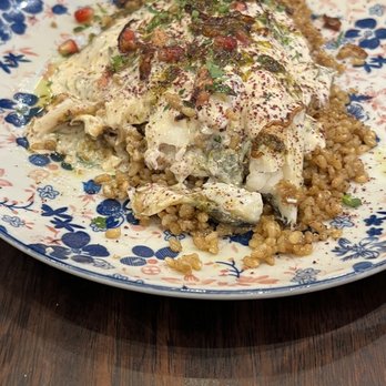 Comptoir Libanais - Sea bass with pomegranate tahini sauce over short grain rice - Lebanese Near Me - London, XGL Comptoir Libanais - Sea bass with pomegranate tahini sauce over short grain rice - Lebanese Near Me - London, XGL