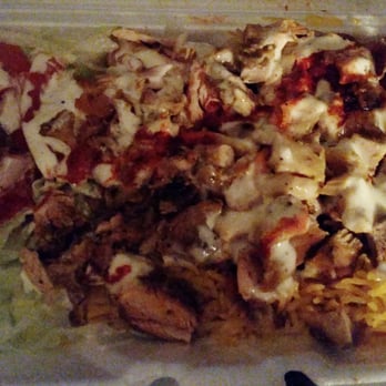 Hooda Halal Cart - Chicken over yellow rice with white sauce and hot sauce. Yum! - Food Trucks Near Me - New York, New York