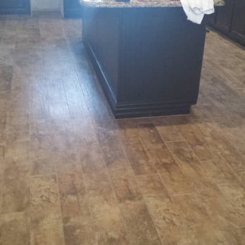 Unique Flooring & Design - a kitchen with wood floors - Kitchen & Bath Near Me - Oviedo, Florida