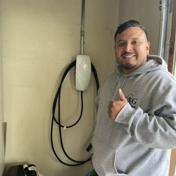 MAG Electric - Owner Mark Gonzalez with the Tesla charger he installed - Electricians Near Me MAG Electric - Owner Mark Gonzalez with the Tesla charger he installed - Electricians Near Me