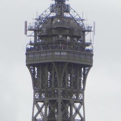City Wonders - Eiffel Tower Summit on 02. April 2024, picture taken from Arc de Triomphe. Crowded with people.