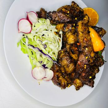 Mcuire - a plate of food on a table - African Near Me - Niagara Falls, Ontario