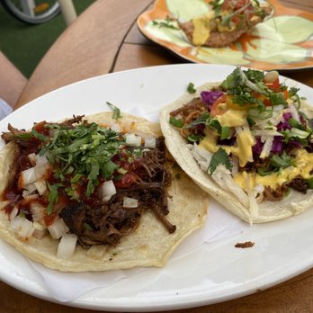 PapiChulo Tacos - Jupiter - Barbacoa Taco (on the left) and Puerco Taco (on the right) with the Short Rib Empanada in the background. - Tacos Near Me - Tequesta, Florida PapiChulo Tacos - Jupiter - Barbacoa Taco (on the left) and Puerco Taco (on the right) with the Short Rib Empanada in the background. - Tacos Near Me - Tequesta, Florida
