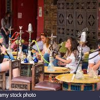 Jafra Hookah Lounge - a group of people sitting outside a restaurant - Hookah Bars Near Me - Columbus, Ohio