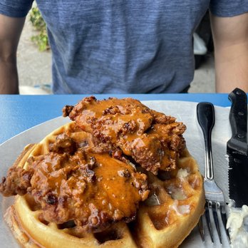 The Westy - Fried chicken and waffle with Pterodactyl hot sauce, honey butter and cinnamon whiskey syrup - Sports Bars Near Me - Seattle, Washington The Westy - Fried chicken and waffle with Pterodactyl hot sauce, honey butter and cinnamon whiskey syrup - Sports Bars Near Me - Seattle, Washington
