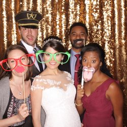 Orlando Photobooths - A bride with her friends in our open air photo kiosk with our Gold Metallic Sequins Backdrop.
