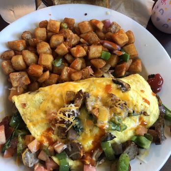 Scotts Diner - Country potatoes, Veggie Omelette with all meats with tomatoes added, Tapatio and Cholula hot sauce. Had alot left over! - Diners Near Me - Merced, California