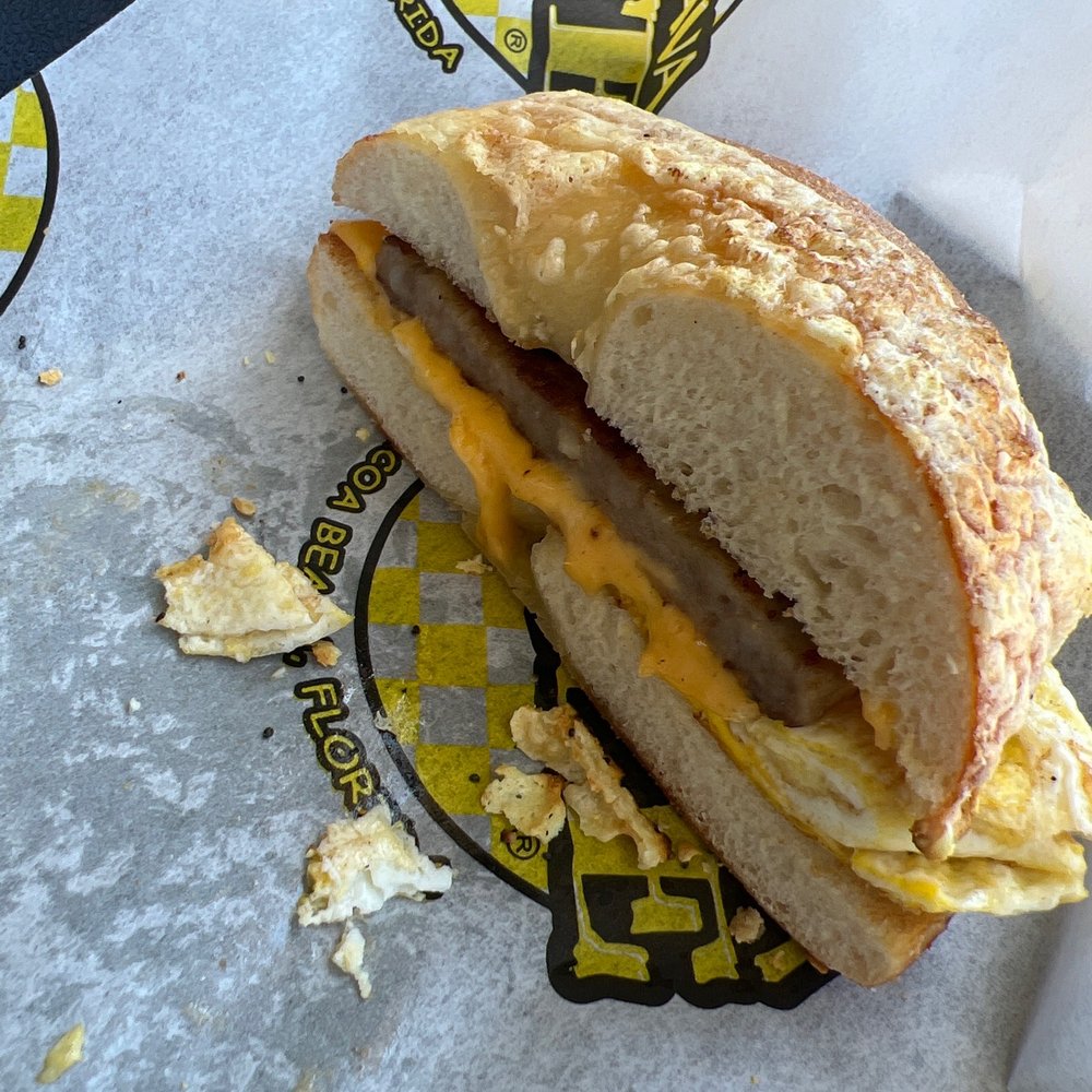 Juice 'N Java Cafe - Asiago bagel with sausage egg and cheese. Delicious. - Coffee & Tea Near Me - Cocoa Beach, Florida Juice 'N Java Cafe - Asiago bagel with sausage egg and cheese. Delicious. - Coffee & Tea Near Me - Cocoa Beach, Florida