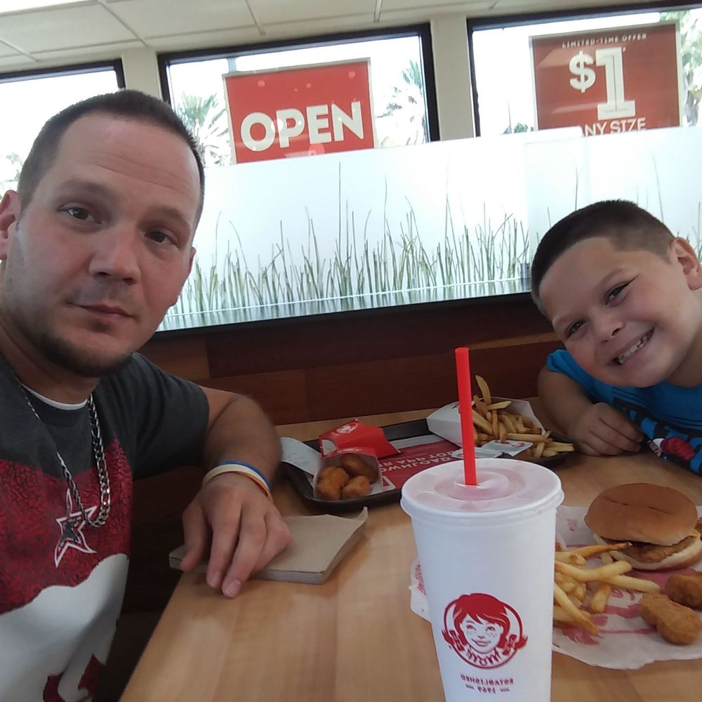 a man and a boy sitting at a table a man and a boy sitting at a table
