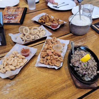Isla Restaurant - Top counter clockwise- rice, lumpia shanghai,  calamares, popcorn shrimp, fresh chicharon, and sisig kapampangan - Filipino Near Me - San Bruno, California