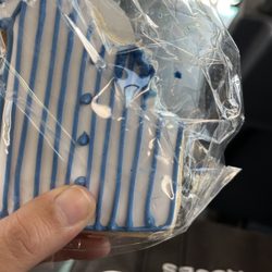 David Burke's Dixie Lee Bakery - Hair on the white layer of icing, pinned with the blue layer. Tells me this happened during the decorative process.