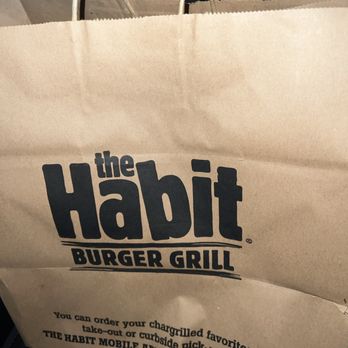 Habit Burger & Grill - a paper bag with the habit burger grill logo - Burgers Near Me - Hanford, California