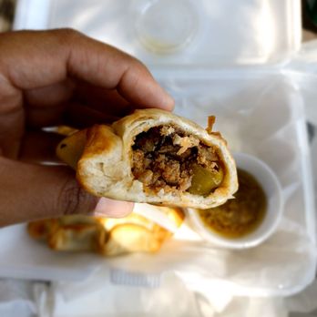 Empanadas To Go - a hand holding a sandwich - Argentine Near Me - Chino, California Empanadas To Go - a hand holding a sandwich - Argentine Near Me - Chino, California