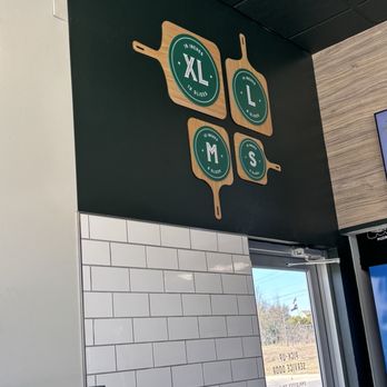 Marco's Pizza - Size of the pizzas on the pizza peels on the wall. - Italian Near Me - Hewitt, Texas