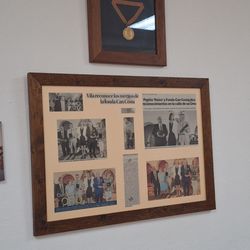 Ca'n Costa - Framed awards and press recognition on display.