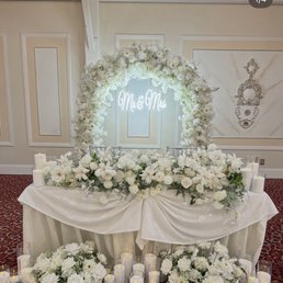 Sweetheart table, sand candles, florals Sweetheart table, sand candles, florals