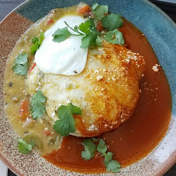 Panxa Cocina - bird's eye view of the brunch Stacked Enchiladas w/ short rib, christmas salsa, & fried egg slidin off the top - great rich flavors! - Cocktail Bars Near Me - Long Beach, California