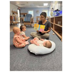 Montessori Stepping Stones - Montessori teacher reading to babies and toddlers in our Montessori daycare in Mount Clemens, MI.