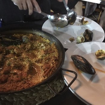 SER - The seafood paella being plated - Spanish Near Me - Arlington, Virginia SER - The seafood paella being plated - Spanish Near Me - Arlington, Virginia