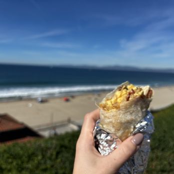Phanny's - a person holding a burrito on the beach - Breakfast & Brunch Near Me - Redondo Beach, California Phanny's - a person holding a burrito on the beach - Breakfast & Brunch Near Me - Redondo Beach, California