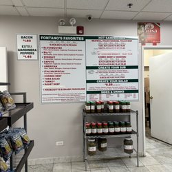 Fontano’s Subs - The menu board, with a display of hot peppers underneath