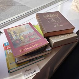 a stack of books on a window sill