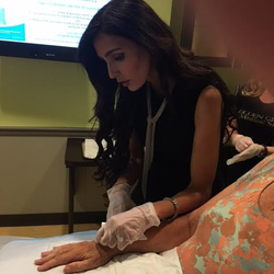 Golden Glow Medical Spa - Dr. Mira Mahajan injecting Radiesse into the hands of a patient.