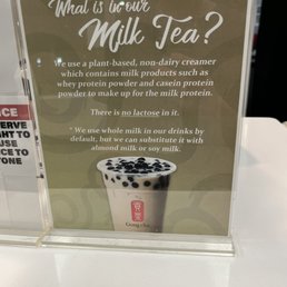 A sign at Gong Cha in Union, NJ, describes their plant-based, non-dairy milk tea with milk protein powder and no lactose, featuring an image of the drink.