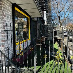 Suzy's Roti Parlour - Outside seating area with tables and chairs