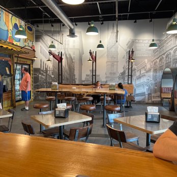 Pita Chip - a man sitting at a table in a restaurant - Middle Eastern Near Me - Yardley, Pennsylvania