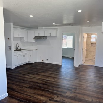 OP Construction - an empty kitchen and living room - General Contractors Near Me