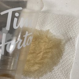 What appears to be a hair pictured on paper towel. What appears to be a hair pictured on paper towel.