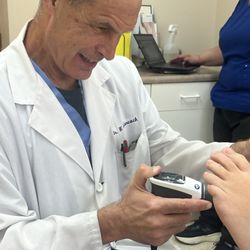 Dr. Johncock providing Shockwave Treatment to patient with Plantar Fasciitis